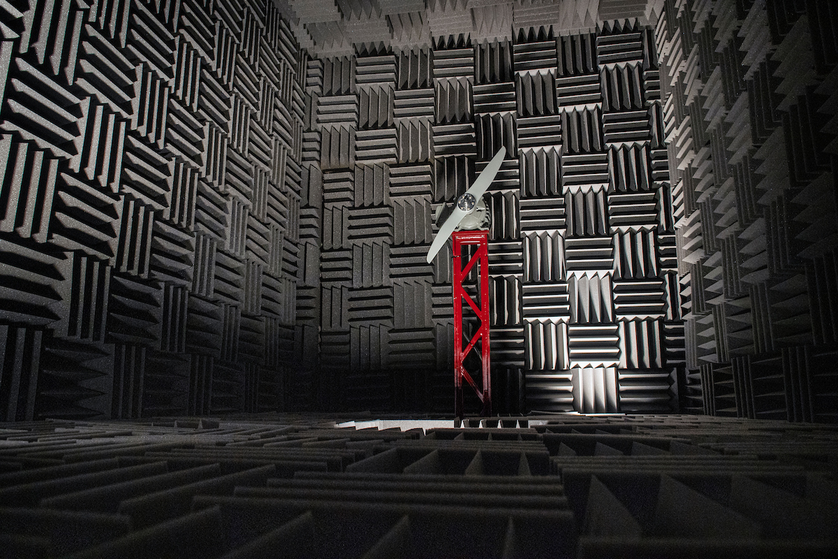A propeller mounted to a test stand is shown inside the flight lab's acoustic anechoic chamber.
