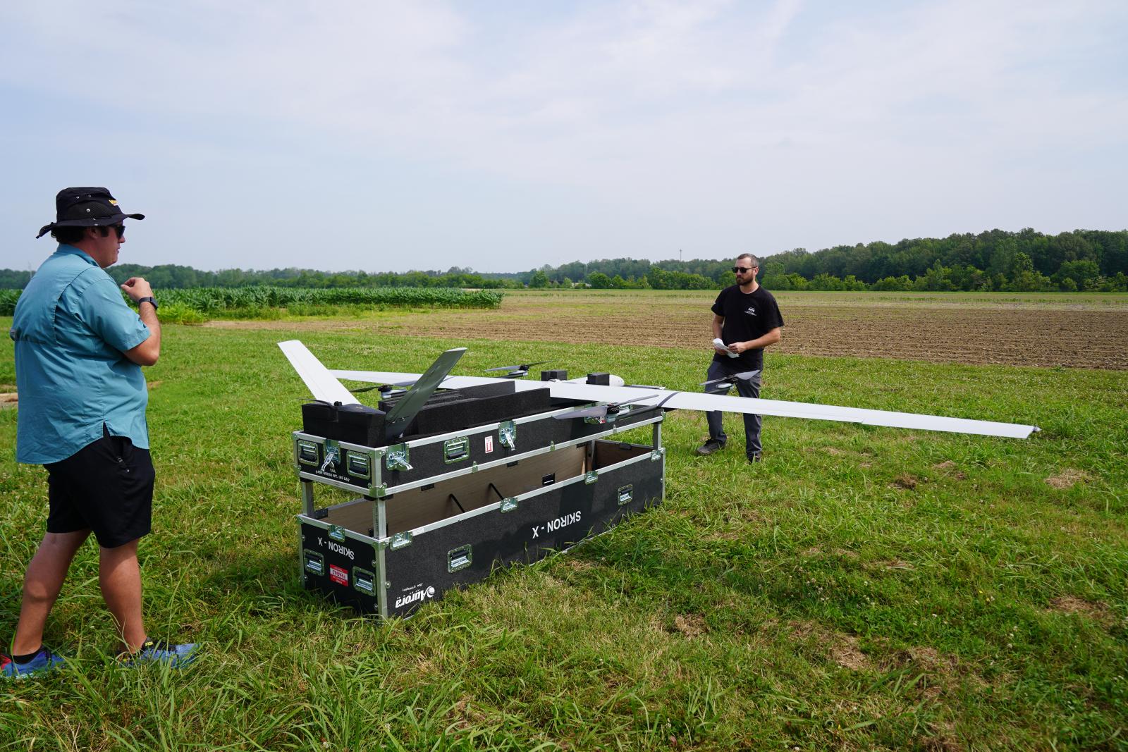Raspet flight technician Charley Zera, right, and an Aurora Flight Sciences engineer prepare the SKIRON-X platform for flight testing on Mississippi State's North Farm. 