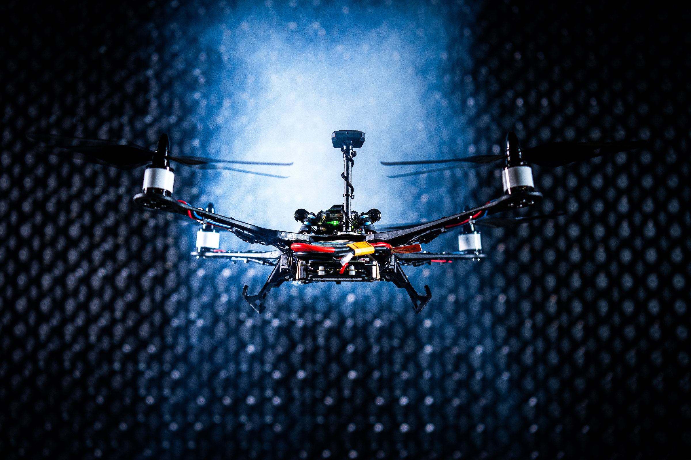 A small UAS hovers in front of a windwall