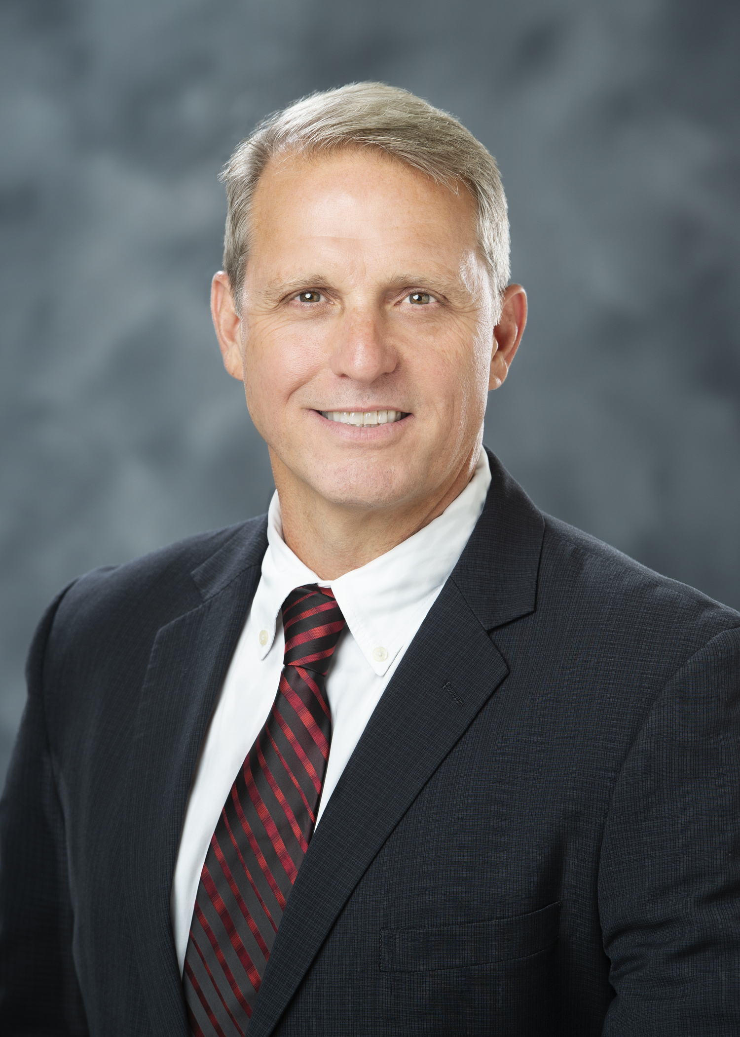 A headshot of Tom Brooks